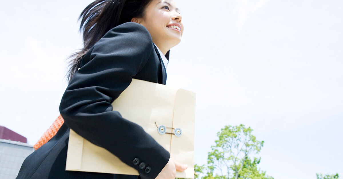 Businesswoman Running With Documents
