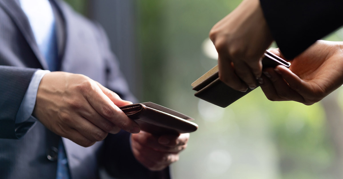 Japanese businessmen exchanging business cards in a formal setting