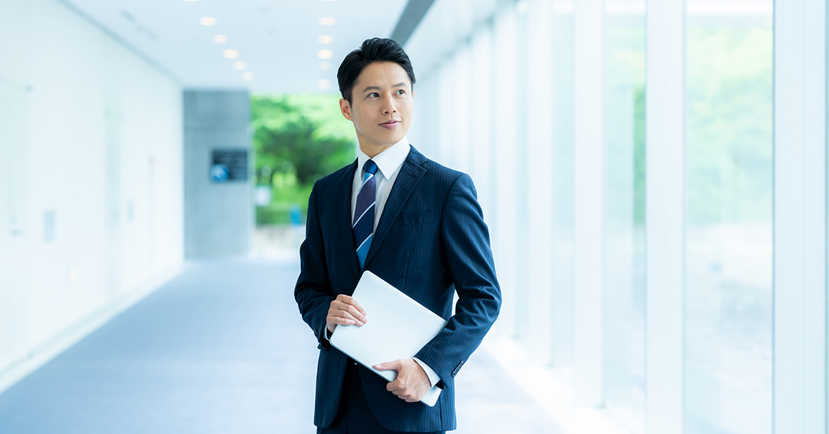 面接に向かうビジネスパーソンが履歴書テンプレートで作成した履歴書を手に歩く様子。