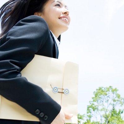 Businesswoman Running With Documents